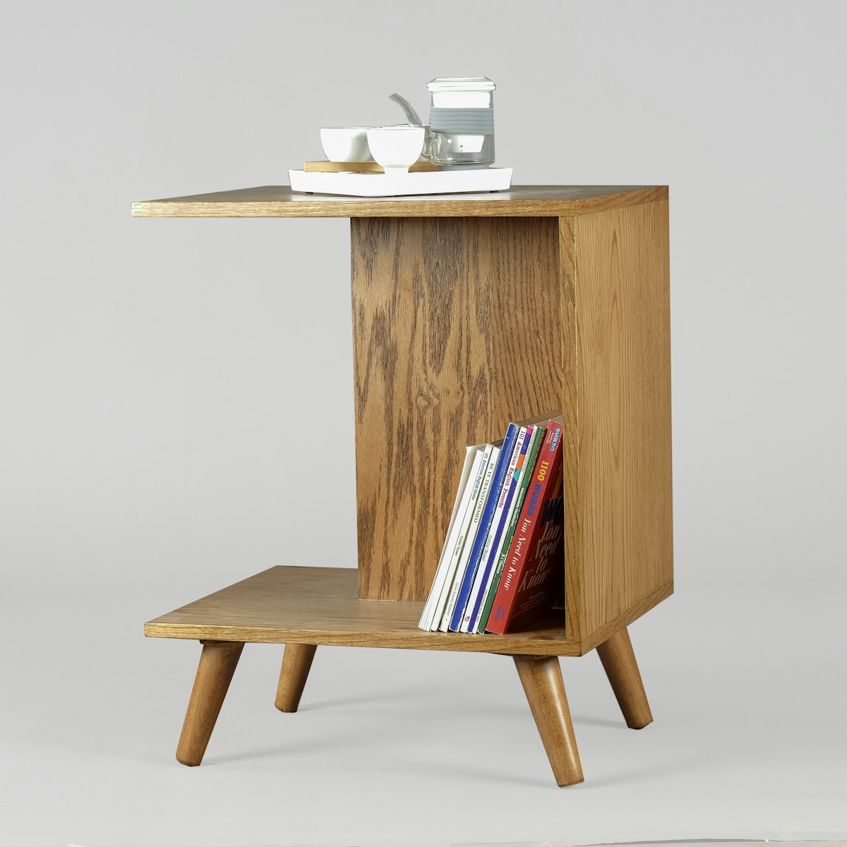 Solid wood C-shaped side table with a magazine shelf